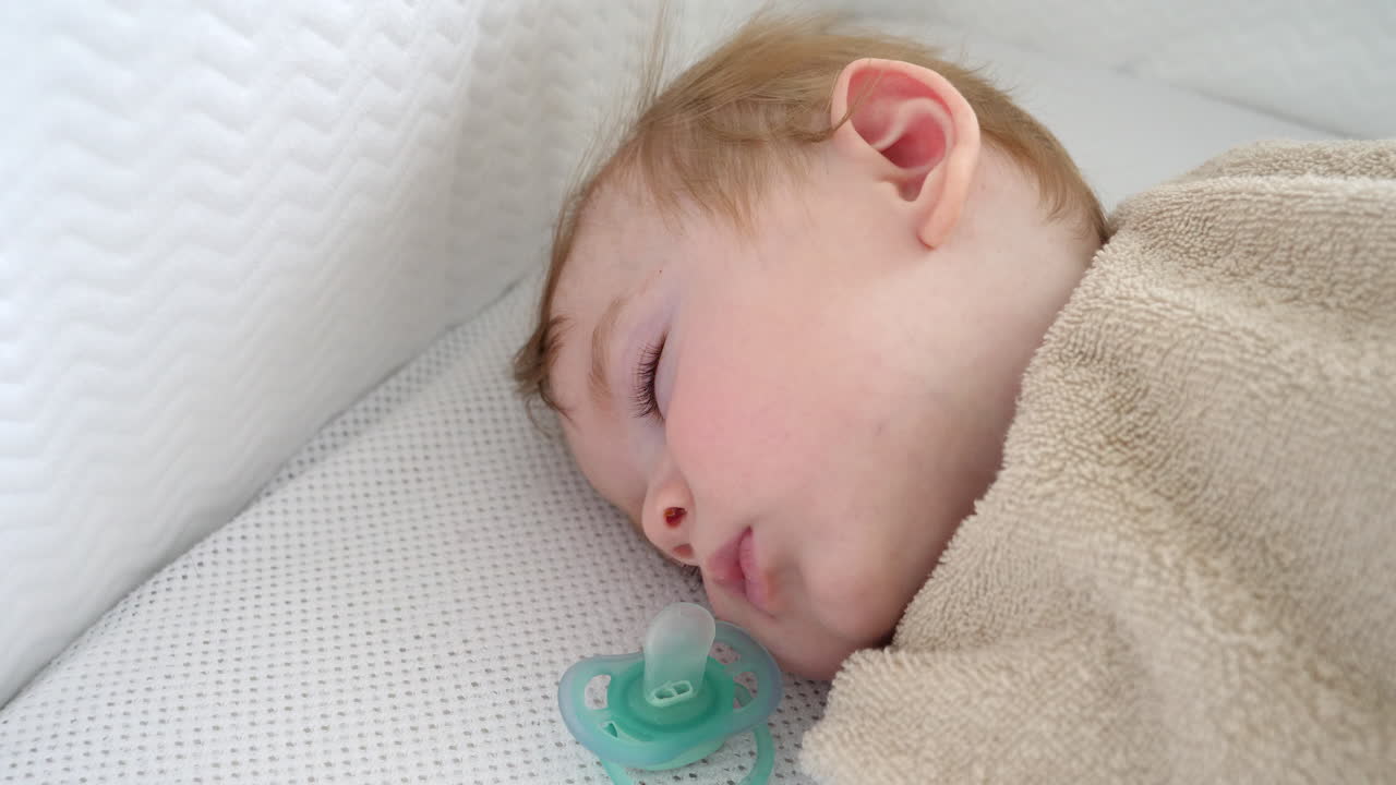 Cute Baby Boy Sleeping in Bed, Gently Awakening, Close Up