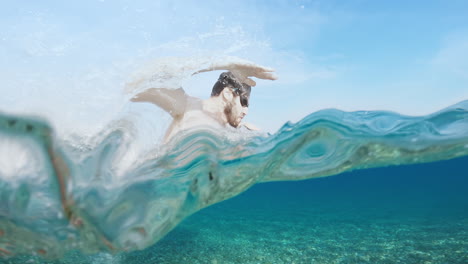 man swimming dolphin style in the ocean