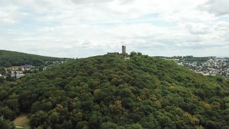 Castle-Königstein-on-a-Hill,-Germany,-flying-towards-and-above-it