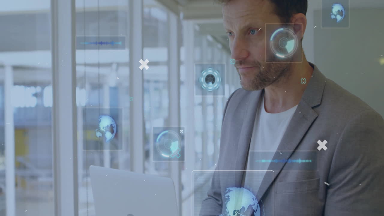 Experienced professional holding laptop in office corridor showing floating holographic tech charts