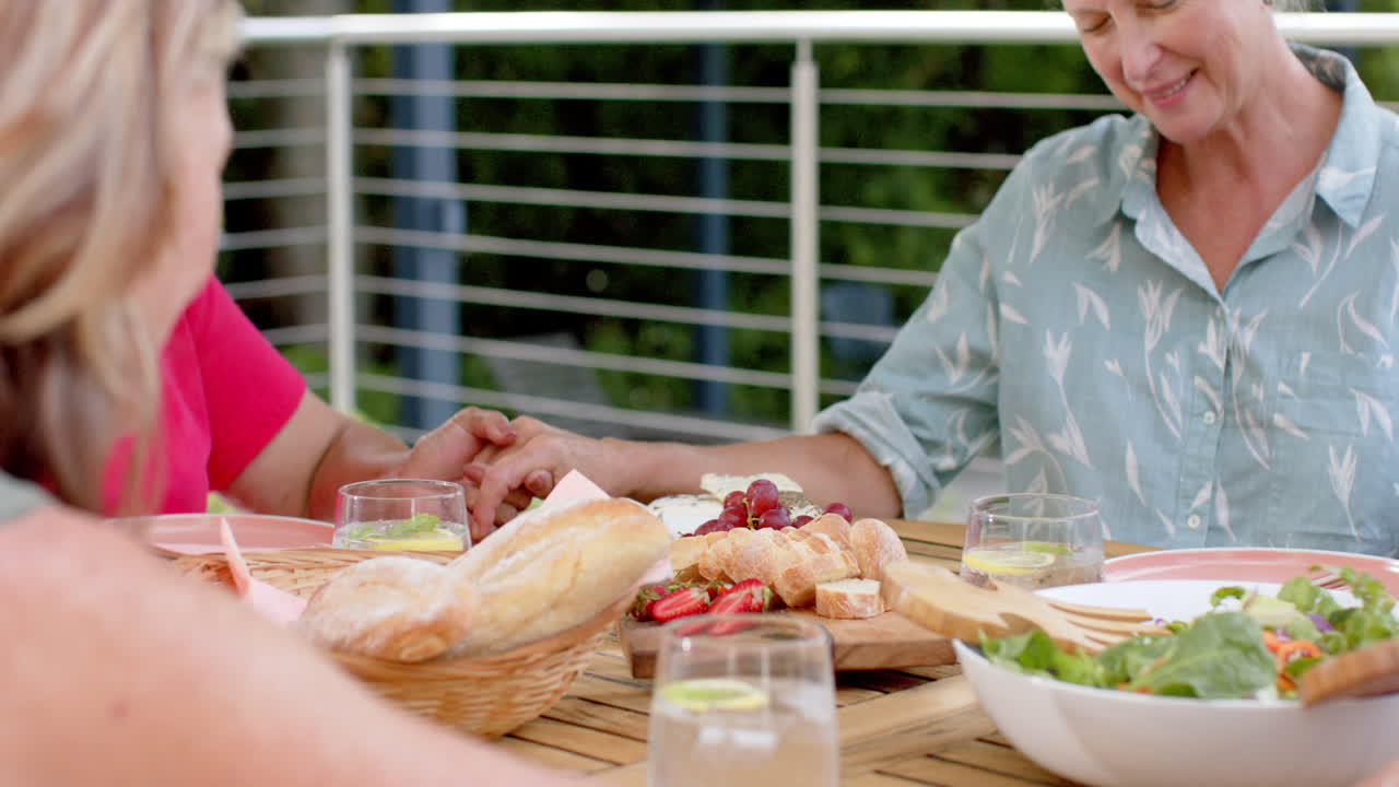 고령 백인 여성들이 야외에서 식사를 즐기고 있습니다.