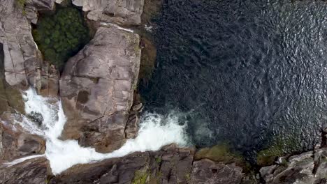 Aerial-View-Across-Water-Cascading-Down-Over-Rocks-In-Behana-Gorge