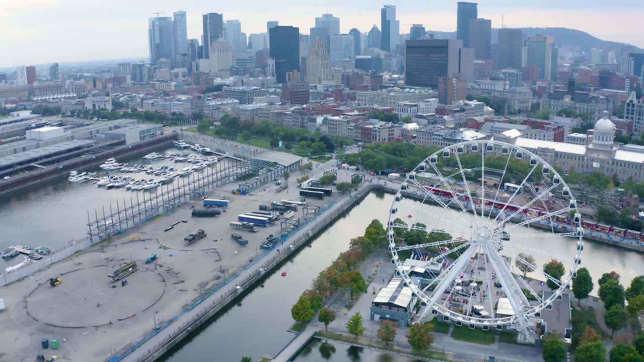 Aerial shot of Montreal's Old Port with the Ferris wheel in view, showcasing the vibrant waterfront and historic architecture. Perfect for capturing the essence of the city.