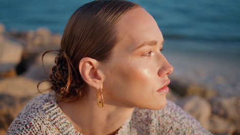 portrait gorgeous woman posing in golden sunlight. gentle pensive girl at shore