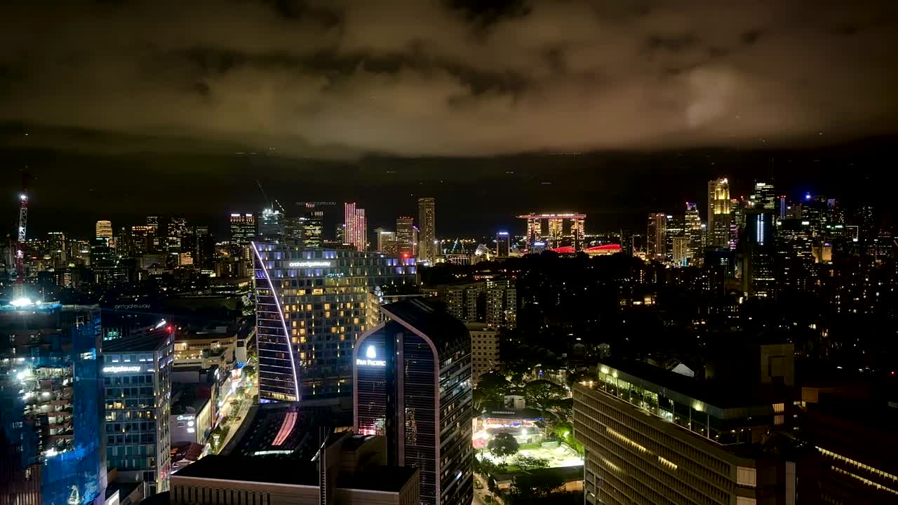 Singapore skyline at night with bright lights flashing