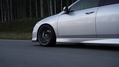 silver sedan on a country road