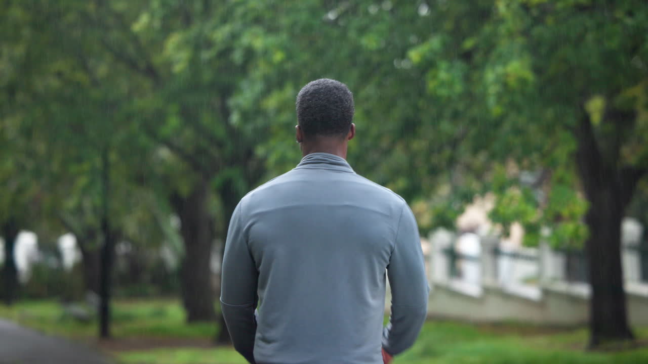 비가 오는 동안 스트레칭하는 남자