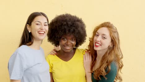 three diverse young women smiling together