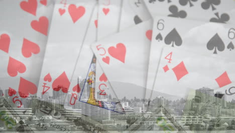 animation of playing cards and american dollar banknotes over cityscape