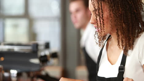 smiling waitress picking rolls with tongs