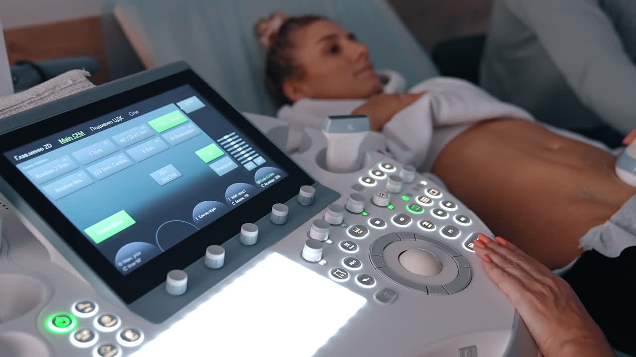 Obstetrician performs ultrasonic examination for the pregnant lady. Future parents having ultrasound examination.