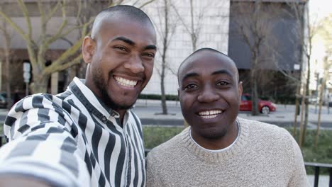 smiling african american guys recording video message