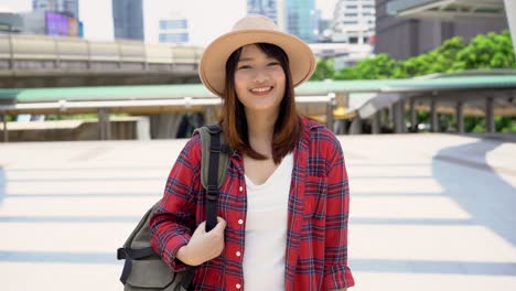 attractive young smiling asian woman outdoors portrait in the city real people series. outdoors lifestyle fashion portrait of happy smiling asian girl. summer outdoor happiness portrait concept.