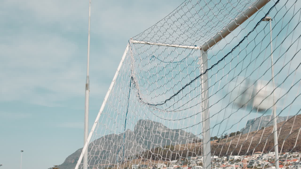 Soccer goal with a mountain in the background