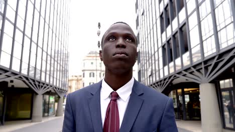 success, business, leadership- black african business man looking up - outdoor