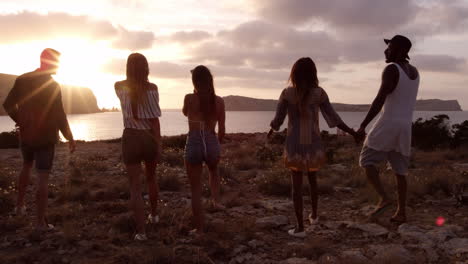 friends walking on cliff watching sunset shot on r3d