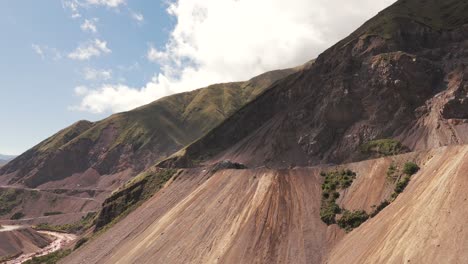 Fly-over-mountains-affected-by-limestone-mining-in-Jujuy,-Argentina-with-arid-and-sediment-filled-soils-resulting-from-large-scale-mining