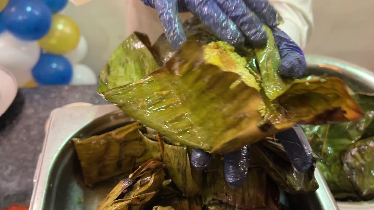 Famous bhetki Paturi covered in leaf and steamed prior to serving.