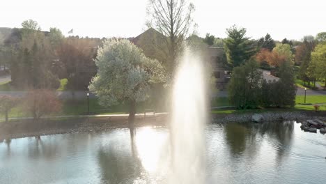 water fountain spray and wind blow into aerial drone shot under beautiful light