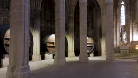room with wine barrels inside a french abbey.