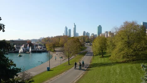 people running and cycling on chicago's lakefront path on beautiful autumn day