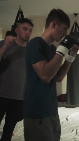 sportsmen group runs around boxing gym. kick-boxer team trains together on rink in combat club slow motion. men warm up before fighting indoors