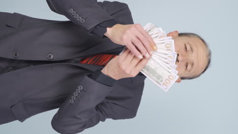 Vertical-video-of-Old-businessman-who-loves-money.