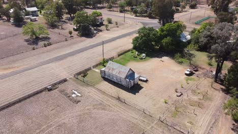 Aerial-view-of-a-small-country-catholic-chapel-located-next-to-the-main-road-with-intersections