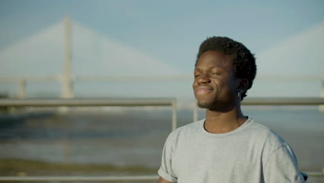 happy black guy taking selfie on his mobile phone at seashore