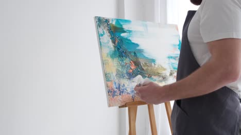 a young artist at work he works with inspiration paints a picture happy to do what he really likes - a young artist at work, he works with inspiration, paints a picture, happy to do what he really likes