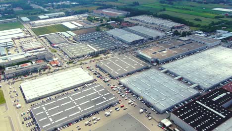 aerial footage of a large shopping centre and car parks located in the city