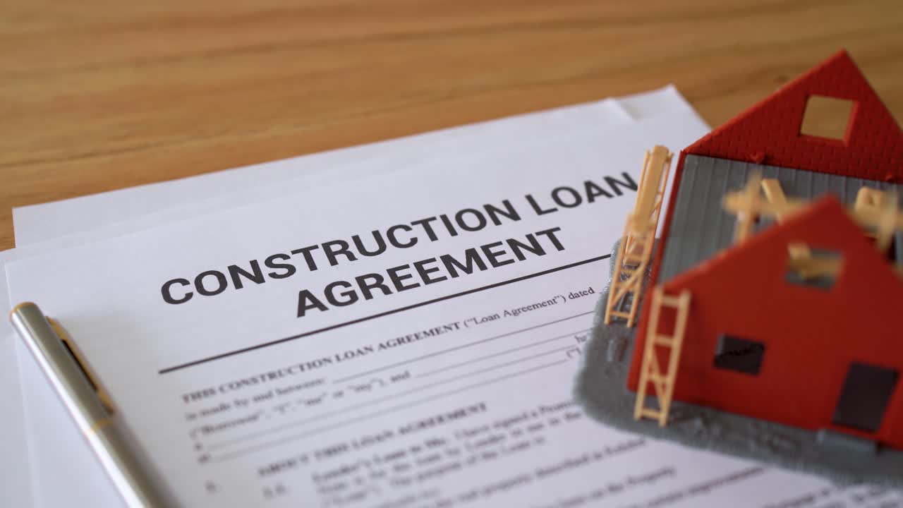 Construction loan agreement contract papers. Concept of getting a loan for building a home.