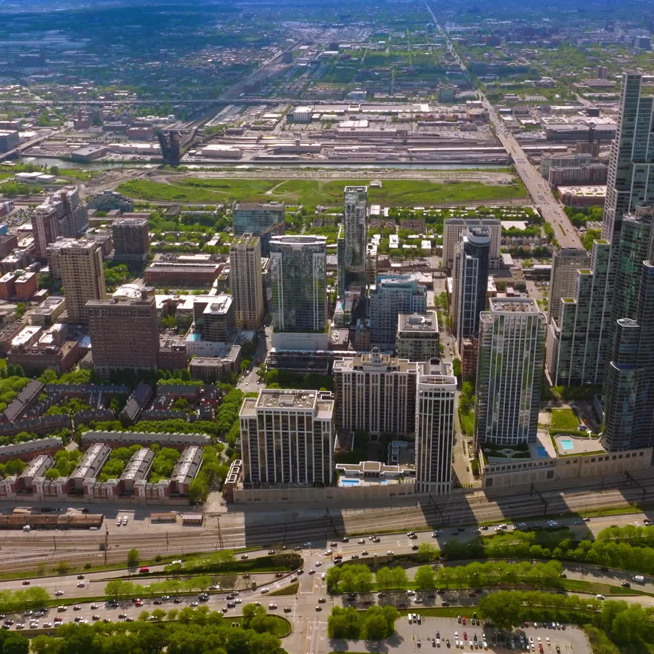Modern abundant city panorama on sunny day. Beautiful Chicago scenery from aerial perspective. Crazy traffic at foreground
