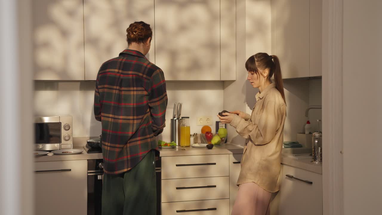 Couple cooking breakfast in the kitchen