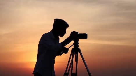 silhouette of a photographer at sunset