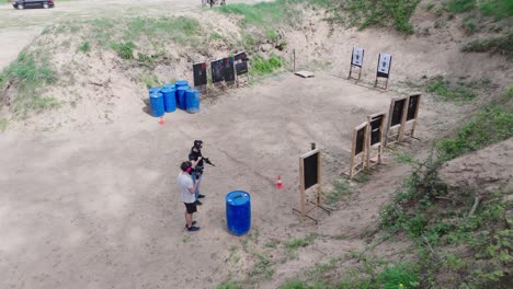 High-angle-view-over-shooting-range-with-male-with-weapon-and-camera-equipment