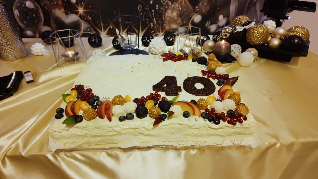 Elegant 40th birthday cake with fruits chocolate and gold decorations
