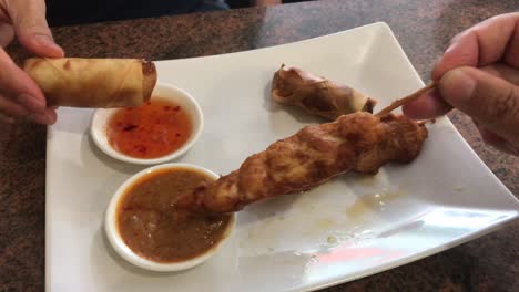 eating spring rolls and deep fried chicken