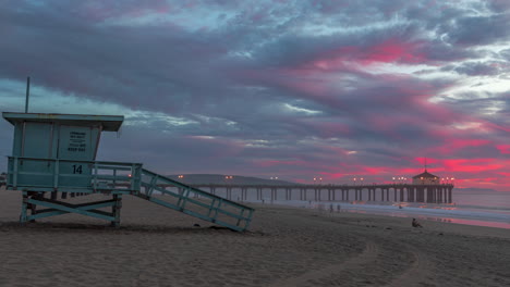 lifeguard tower at manhattan beach during sunset with pier in the distance