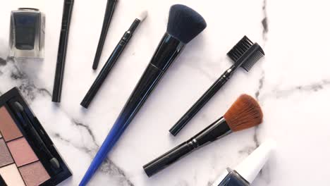 makeup brushes and tools on marble