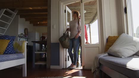 happy cacusia mature couple coming with suitcases to hotel room