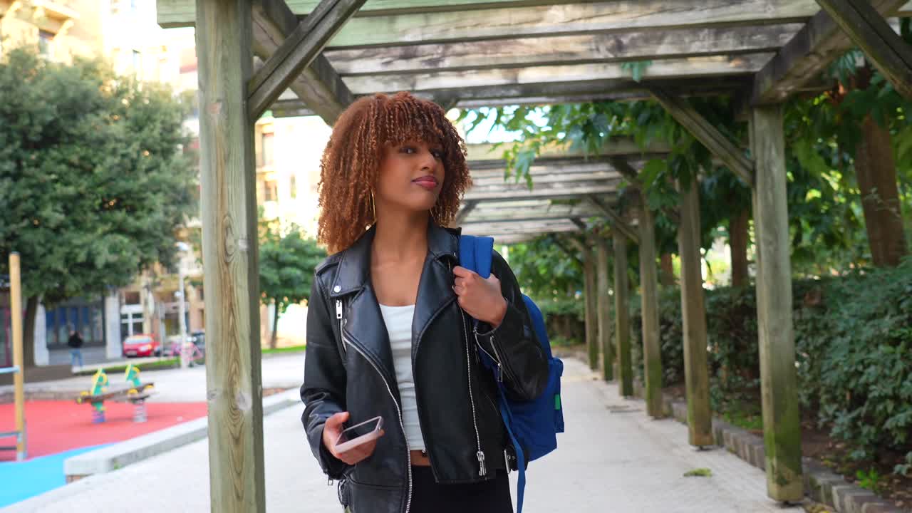 Woman with Backpack Walking in Park