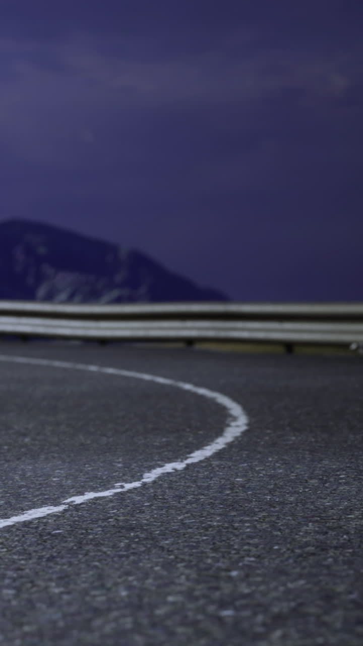 Curva su una strada di montagna tortuosa alla luce della sera con cielo limpido