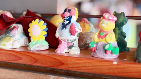 painted figurines displayed at a vibrant market