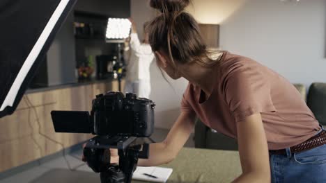 two female women checking camera and lights before recording