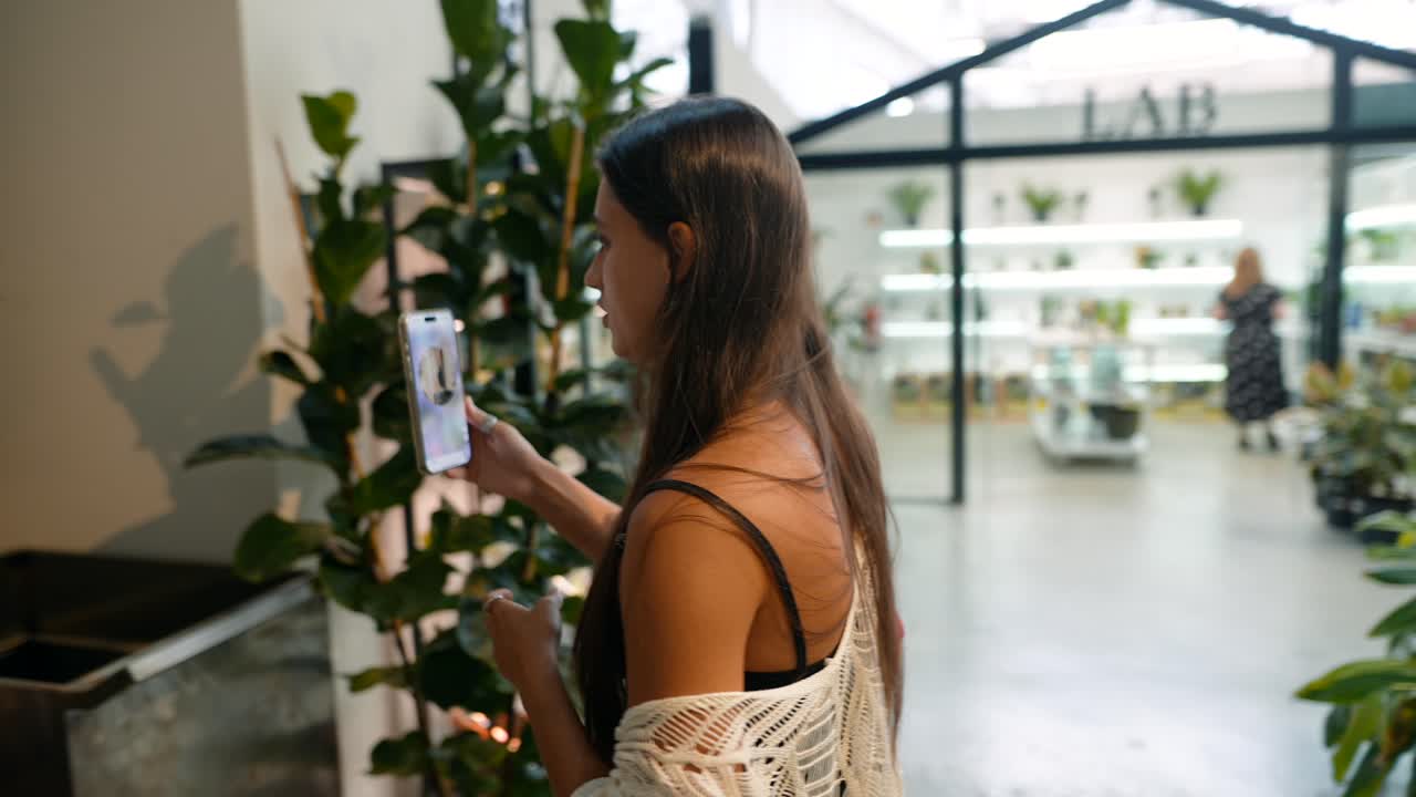 A woman taking photos indoors