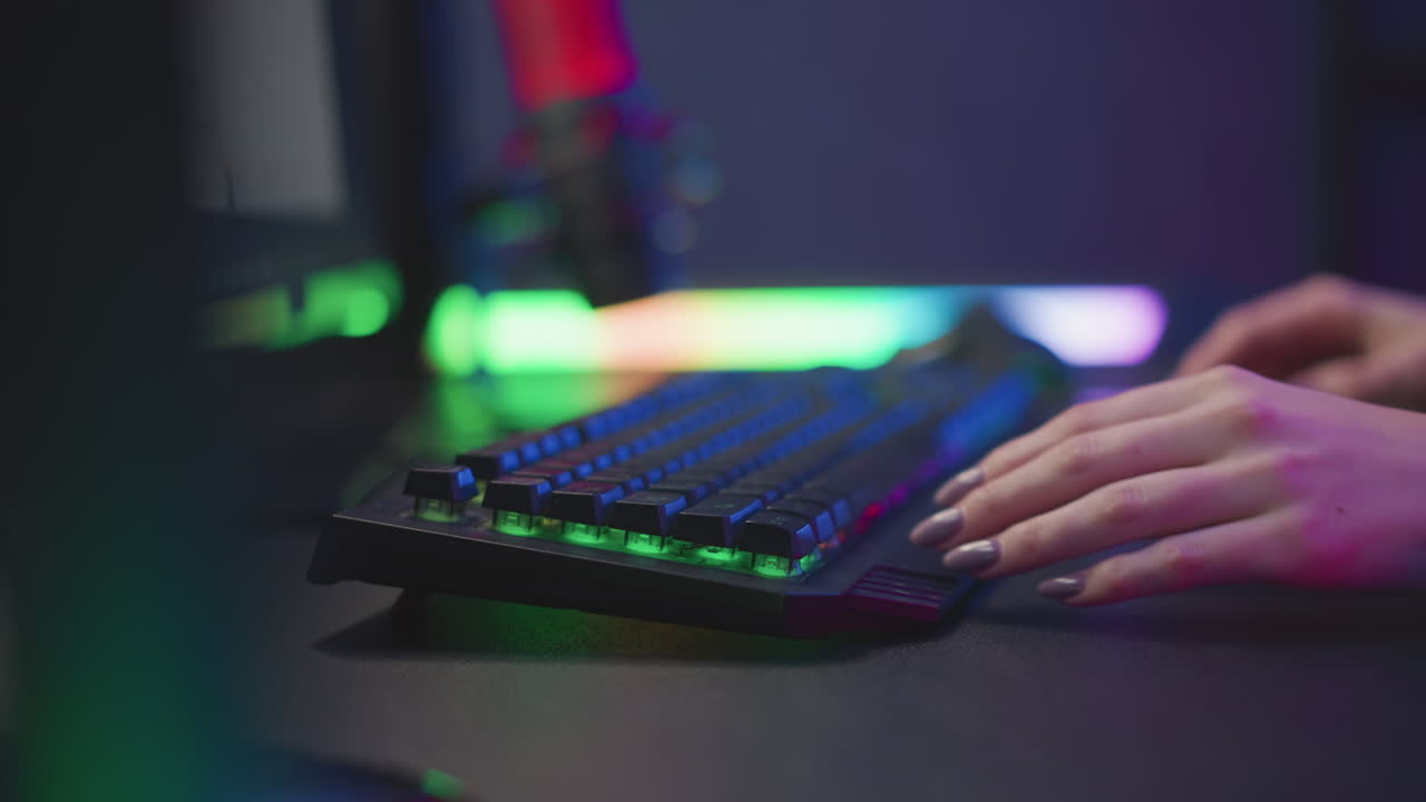 lady in fluffy sweater slowly adjusting sleek rgb keyboard close to desktop screen glowing soft vibrant light fingers with polished nails in colorful ambient dim modern digital tech workspace