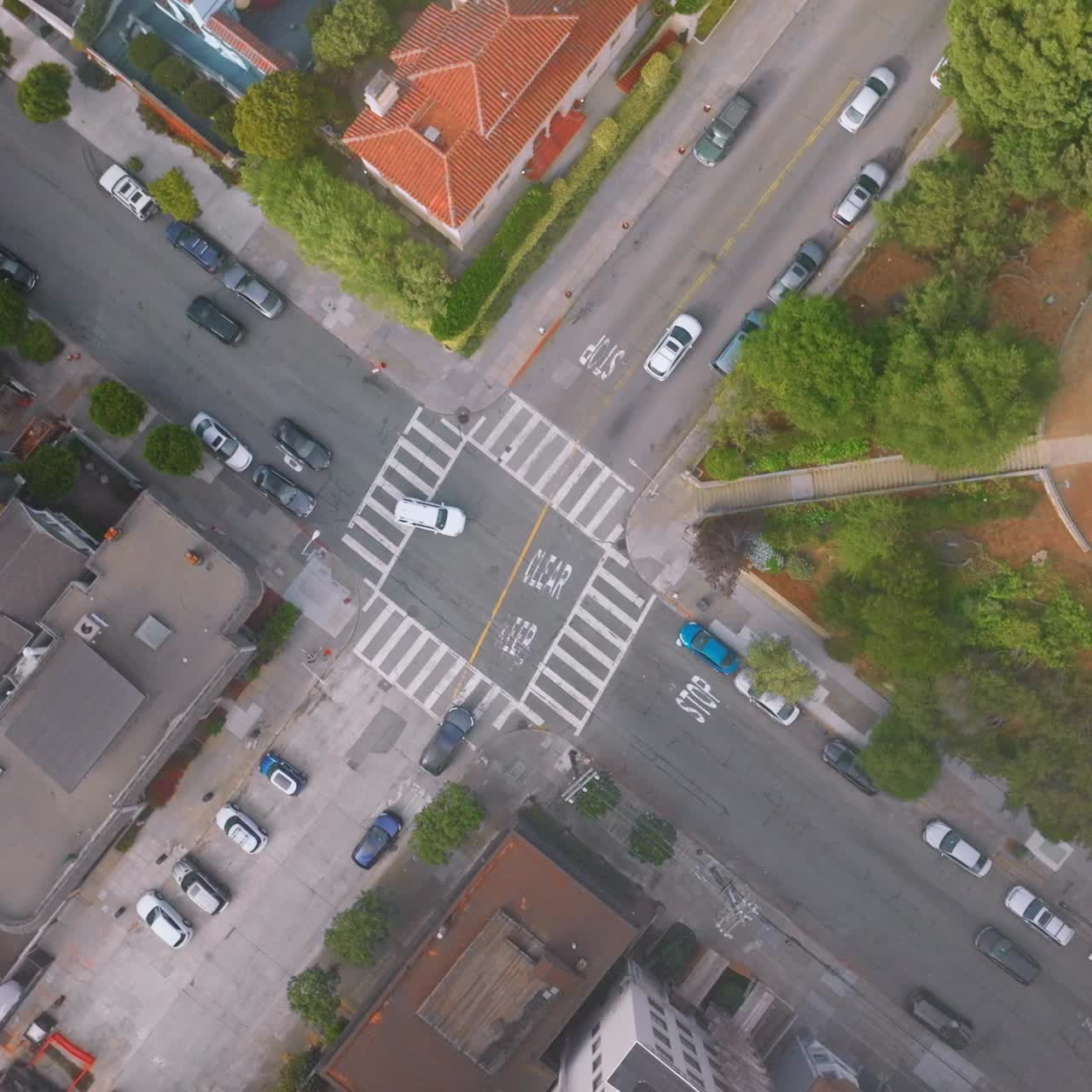 Usual crossroads in one of the streets of San Francisco. Some cars going by the roads of the city. Top view