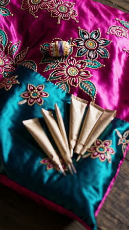 indian wedding decor with henna and embroidered pillows