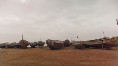 colorful fishing boats standing on the sand in the senegal coast